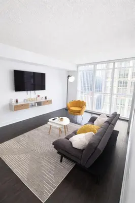 a living room with a couch and a tv at Fully furnished Lux 1bedroom condo in Toronto