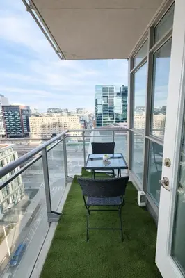 a balcony with a table and chairs on it at Fully furnished Lux 1bedroom condo in Toronto