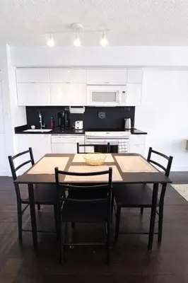 a kitchen with a table and chairs in a room at Fully furnished Lux 1bedroom condo in Toronto