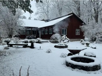 a house with a yard covered in snow at Peaceful Forest Retreat with Fire Pit and BBQ near Mansfield Ski Club in Mulmur