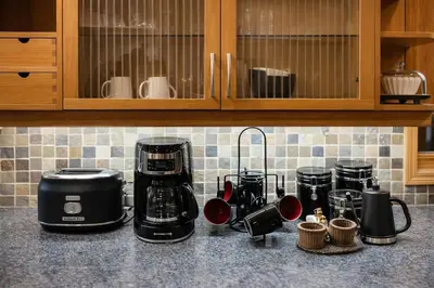 a kitchen counter with coffee makers on a counter top at Peaceful Forest Retreat with Fire Pit and BBQ near Mansfield Ski Club in Mulmur