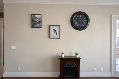 a room with a fireplace and a clock on the wall at Luxury Penthouse with Celebration Square Views in Mississauga