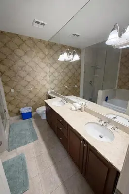 a bathroom with two sinks and a large mirror at Luxury Penthouse with Celebration Square Views in Mississauga