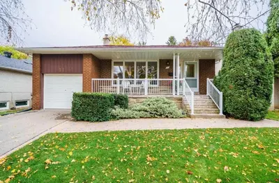 a brick house with a porch and a lawn at Bachelor Suite Near Transit - Private Stay in Toronto Registration number STR-2503-FSHPPQ in Toronto