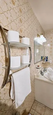 a bathroom with towels and a sink and a mirror at Luxury 3BR Near Pearson Airport Free Parking in Toronto