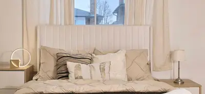 a bedroom with a bed with pillows and a window at Luxury 3BR Near Pearson Airport Free Parking in Toronto