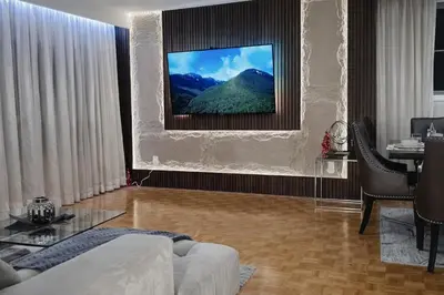 a living room with a couch and a television at Luxury 3BR Near Pearson Airport Free Parking in Toronto