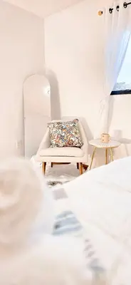 a bedroom with a bed and a chair and a mirror at Luxury 3BR Near Pearson Airport Free Parking in Toronto