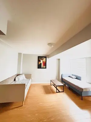 a bedroom with two beds and a table in it at Luxury home Netflix & parking promo price with 7beds in Brampton