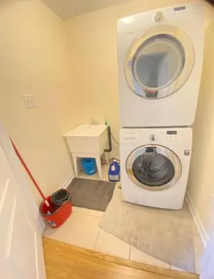 a washer and dryer in a small room at Luxury home Netflix & parking promo price with 7beds in Brampton