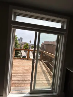 a window with a view of a wooden deck at Luxury home Netflix & parking promo price with 7beds in Brampton