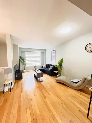 a large living room with a couch and a chair at Luxury home Netflix & parking promo price with 7beds in Brampton