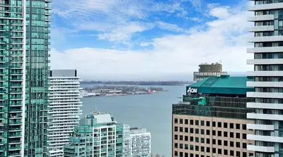 a view of a large city with tall buildings at Luxe 3-Bedroom Lakeview Condo, Free parking ,Walk to CN Tower, Scotiabank Arena & Rogers Centre in Toronto