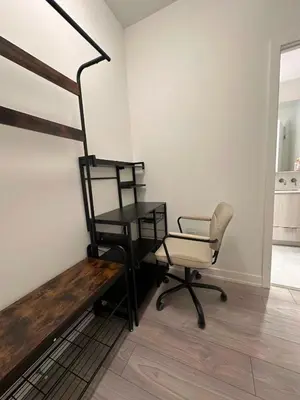 a room with a desk and a chair and a stairway at Cozy studio near Yonge Eglinton Subway Midtown in Toronto