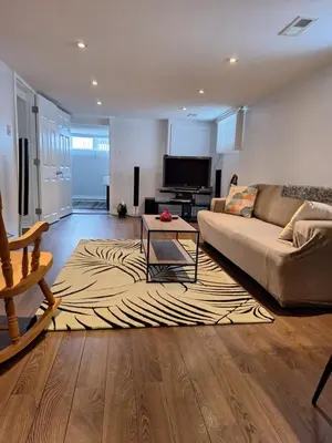 a living room with a couch and a zebra rug at Cozy home in Toronto