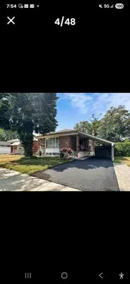 a picture of a house with a driveway at Cozy home in Toronto