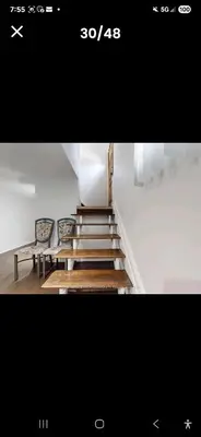 a picture of a staircase with two chairs and a bench at Cozy home in Toronto