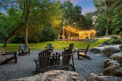 a group of benches in a yard with a house at Evergreen Escape - 3 Acres, Hot Tub, Volleyball Court in Collingwood