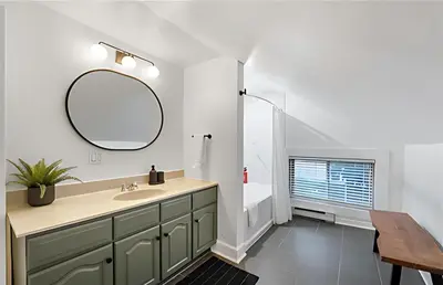 a bathroom with a sink and a mirror at Evergreen Escape - 3 Acres, Hot Tub, Volleyball Court in Collingwood