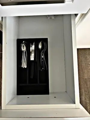 a display case with keys and utensils in it at Cozy Place in Oshawa