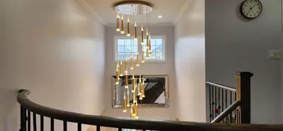 a staircase with a chandelier in a house at Charming Room in Brampton