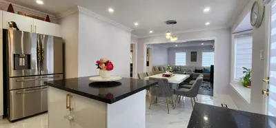 a kitchen and living room with a table and a dining room at Charming Room in Brampton