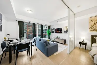 a living room and dining room with a dining table at Spacious Condo with 2 Beds Unbeatable Location in Toronto