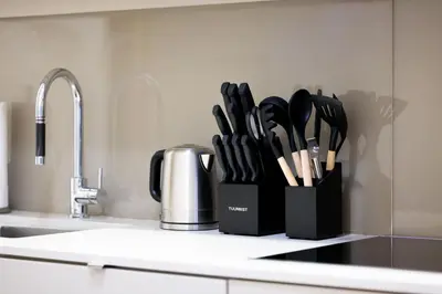 a kitchen counter with a knife block with utensils at Spacious Condo with 2 Beds Unbeatable Location in Toronto