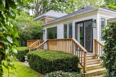 a small house with a wooden deck and stairs at New Modern Home in Old Town in Niagara on the Lake