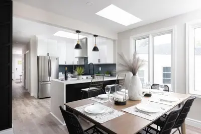 a kitchen and dining room with a table and chairs at New Modern Home in Old Town in Niagara on the Lake
