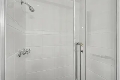 a bathroom with a shower with a glass door at Upscale Modern Home with Spa Pool in Niagara on the Lake