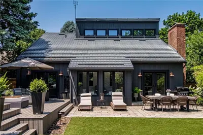 a house with a patio with a table and chairs at Upscale Modern Home with Spa Pool in Niagara on the Lake