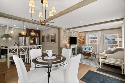 a dining room and living room with a table and chairs at Modern French Cottage in Old Town The 506 in Niagara on the Lake