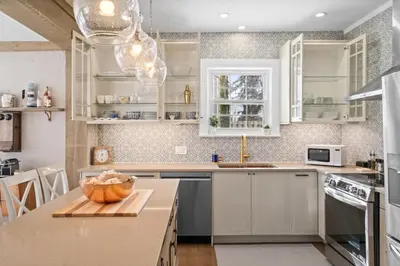 a kitchen with white cabinets and a counter top at Modern French Cottage in Old Town The 506 in Niagara on the Lake