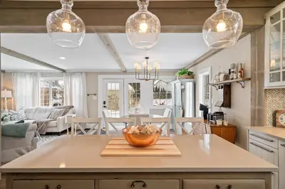 a kitchen with a table with a bowl on a cutting board at Modern French Cottage in Old Town The 506 in Niagara on the Lake