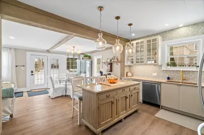 a kitchen with a table and a dining room at Modern French Cottage in Old Town The 506 in Niagara on the Lake