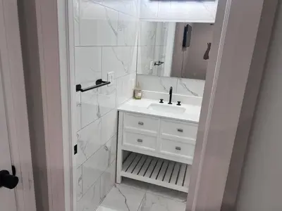 a white bathroom with a sink and a mirror at Pleasant Private Room In Cambridge 02 in Cambridge