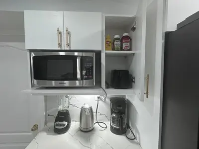 a kitchen with a microwave on a kitchen counter at Spacious 2 Bedroom, 1 Bathroom Luxury Apartment in Brampton