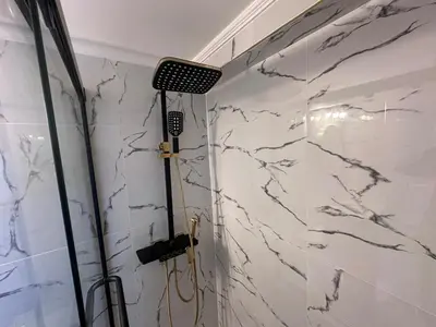 a shower in a bathroom with a marble wall at Spacious 2 Bedroom, 1 Bathroom Luxury Apartment in Brampton