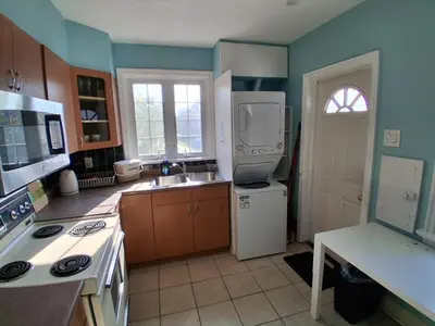 a kitchen with a white refrigerator and a sink at Greenhills - 3 bedroom suit - main floor in Toronto