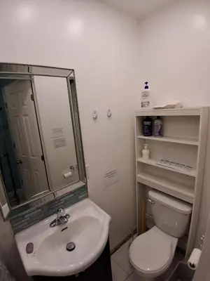 a bathroom with a white toilet and a sink at Greenhills - 3 bedroom suit - main floor in Toronto