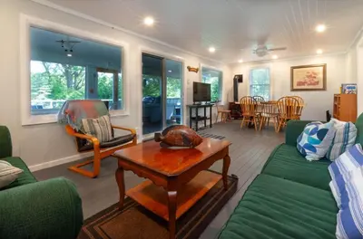 a living room with a couch and a table at Waterfront Muskoka Cottage on Trent-Severn River in Severn