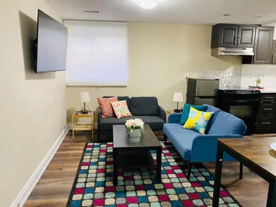 a living room with a blue couch and a table at Relaxing 2 Bedroom Basement Stay in Mississauga