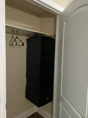 a closet with a black towel hanging on a wall at Relaxing 2 Bedroom Basement Stay in Mississauga