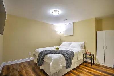 a bedroom with a bed with a blanket on it at Relaxing 2 Bedroom Basement Stay in Mississauga