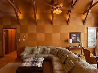 a living room with a couch and a ceiling fan at Private Lakehouse Getaway Hot Tub on the Water in Waubaushene