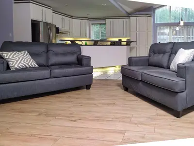 a living room with two couches and a kitchen at Muskoka 4-Bedroom Cottage in Port Carling
