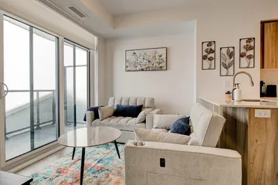 a living room with a couch and a table at Modern High-Rise Condo w City Views & Balcony in Kitchener