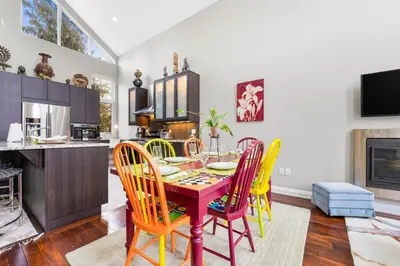 a kitchen and dining room with a table and chairs at Beautiful 3BR Old Town Home Steps to Queen St in Niagara on the Lake