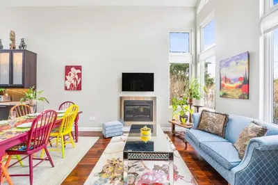 a living room with a blue couch and a table at Beautiful 3BR Old Town Home Steps to Queen St in Niagara on the Lake